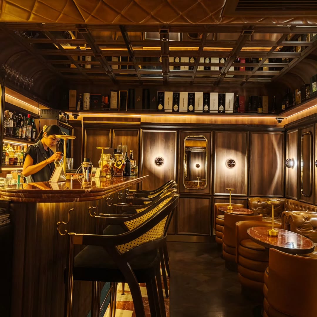 The wood-panelled counter and leather seating at KOUJI ALCHEMIST